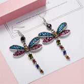 Stunning blue and pink crystal dragonfly earrings with silver plating, featuring delicate, shimmering wings.